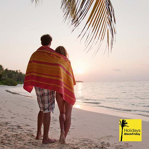 A photograph a couple enjoying their beach towel black friday deal.